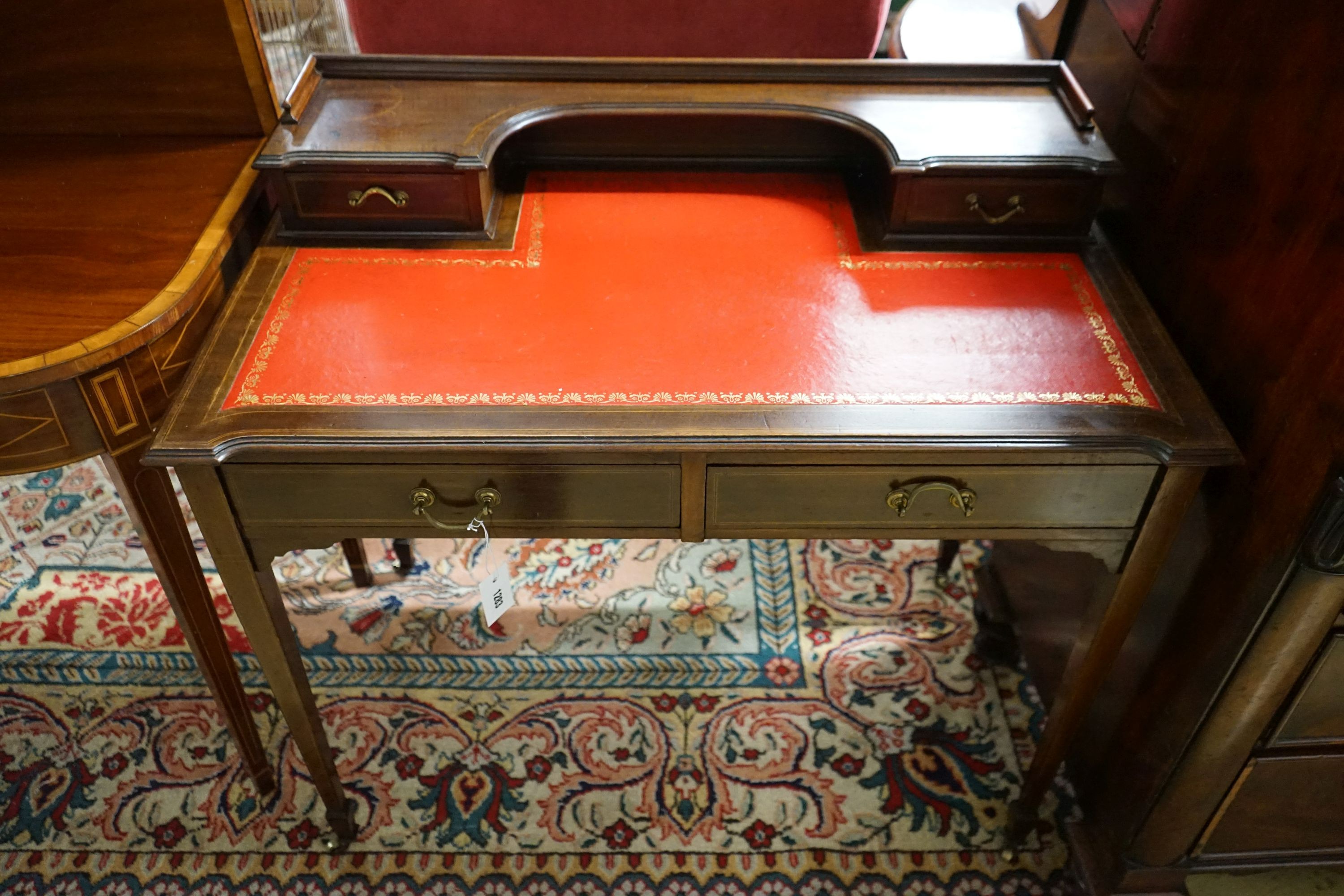 An Edwardian banded mahogany writing table, width 91cm, depth 52cm, height 83cm